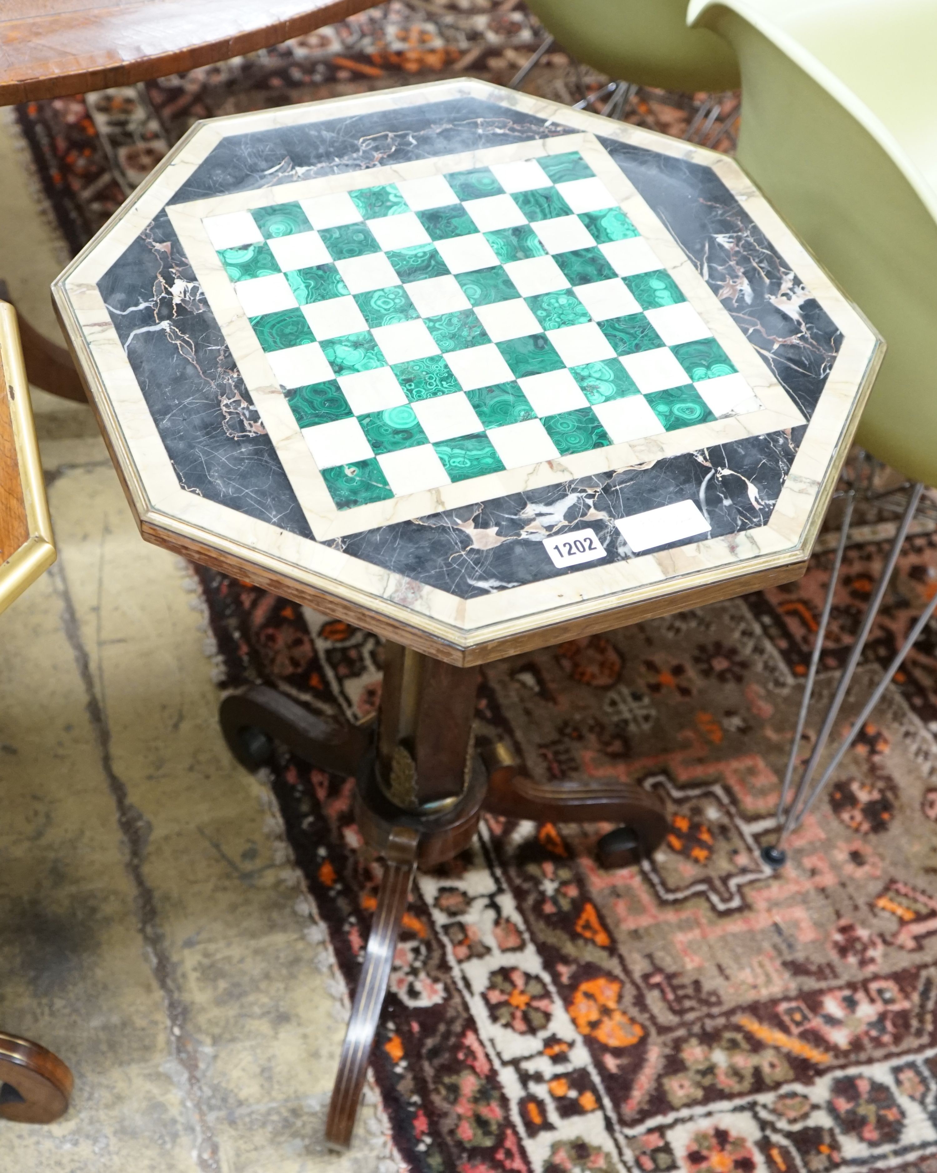 A Regency style brass mounted octagonal rosewood and specimen marble games table, width 49cm, height 70cm